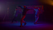 © stockbusters - Cool guys dancing hiphop in flashing backlights. Dancers performing on stage.