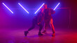 © stockbusters - Professional dancers performing street style on nightclub. Couple moving body.