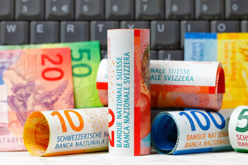 Swiss franc notes and a computer keyboard, CHF