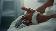 Male patient hand pulse oximeter in ward closeup. Coronavirus hospital treatment