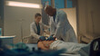 © stockbusters - Doctor performing cpr in emergency unit room. Nurse assisting with oxygen mask.