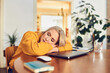 © baranq - Middle aged woman sleeping on her laptop at the table at home