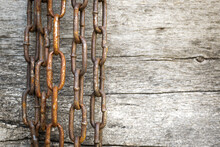 Rusty Chain On The Background Of Wooden Boards. Selective Focus