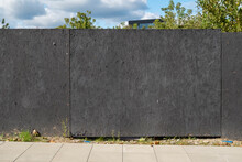 Black Fence Of The Construction Site With Space For Advertisement On A Sunny Summer Day