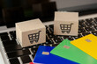 © Achira22 - Shopping online. Credit card and cardboard box with a shopping cart logo on laptop keyboard. Shopping service on The online web. offers home delivery