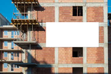 Poster - Advertising banner mock-up mounted on the wall of building under construction