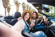 © Davide Angelini - Happy couple driving convertible car on summer vacation - Tourists rent automobile on weekend road trip holiday - Transportation lifestyle concept