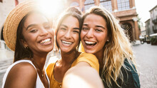 Three Young Women Taking Selfie Walking On City Street - Multiracial Females Picture Smiling At Camera Outside - Friendship And Tourism Concept With Girls Having Fun Together