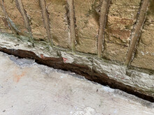 Sinking Concrete Foundation In Need Of Mudjacking Leveling Repair. Sunken Cement Slab Porch.
