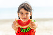 © CandyRetriever  - Little Asian child girl in swimwear eating watermelon while playing with family on tropical beach in sunny day. Happy little girl enjoy and fun outdoor activity lifestyle on summer holiday vacation