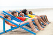 © CandyRetriever  - Group of Smiling diversity little child boy and girl in swimwear lying on beach chair together on tropical beach on summer vacation. Happy children kid enjoy and fun outdoor lifestyle on beach holiday