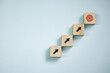 © Panithan - Top view wooden blocks set to step with icon arrow to target. Concept for growth business and targeting.