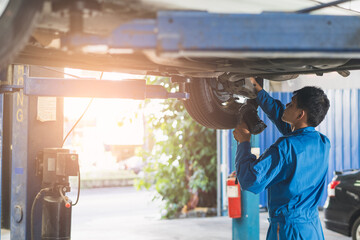 Wall Mural - Auto check up and car service shop concept. Mechanic writing job checklist to clipboard to estimate repair quotation to client at workshop garage.