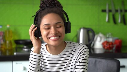 Wall Mural - close up of positive beautiful female listening to music in headphones at home