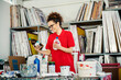 © Dusan Petkovic - A smiling worker looking at bottles with paint thinner in printing shop.