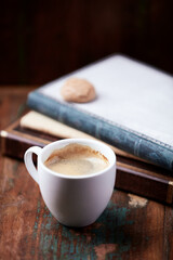 Cup of coffee on rustic wooden background.