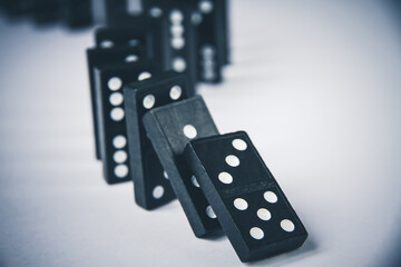 Black dominoes chain on white table background