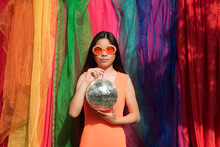 Fine Art Portrait Of A Woman With Disco Ball In Backdrop Of Rainbow Lhbtq Colors