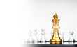 © tete_escape - The Golden king chess piece standing on chessboard in front of silver chess pieces on white background with copy space. Leadership, fighter, competition, confrontation, and business strategy concept.