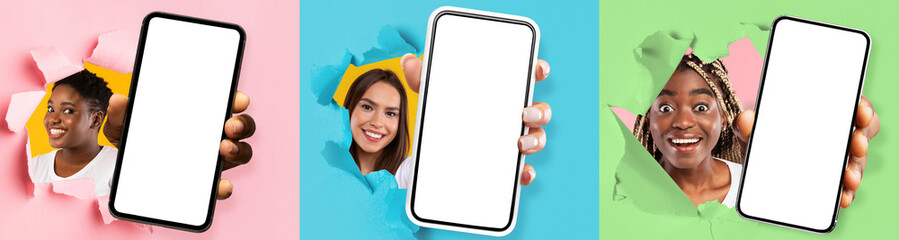 Diverse women showing white empty smartphone screen through torn paper