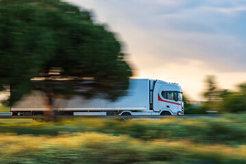 Wall Mural - Truck with a refrigerated semi-trailer traveling fast on the highway, sweeping effect.