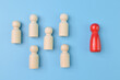© TeacherPhoto - A red wooden people figure standing with a team to influence and empowerment. Leadership, talented, successful people and unique concept