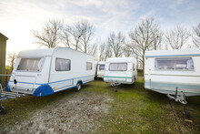 Caravan Trailers Parked On A Green Lawn. Winter. Local Business, Company, Service Concept. Netherlands. RV, Motorhome, Transportation, Road Trip, Traveling, Ecotourism, Lifestyle, Comfort