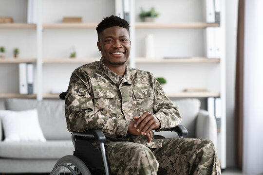 Wall Mural - Positive african american military man sitting in wheelchair, clinic interior
