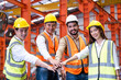 © BritCats Studio - Asian people group of multi mix race worker with supervisor holding hand to cheer up and encourage before working at industrial factory site. Teamwork, labor brainstorm or group working concept.