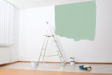 Sticker - Stepladder and painting tools near wall in empty room