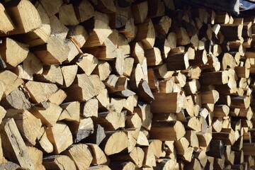 Wall Mural - firewood stacked near the wall close-up