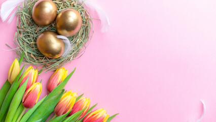 Wall Mural - Easter Golden eggs in basket with spring tulips, white feathers on pastel pink background in Happy Easter decoration. Spring holiday flat lay concept.