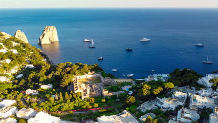 Poster - Faraglioni from Capri Town in Capri, Italy. Aerial view from drone at summer sunset