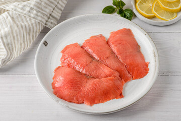 smoked red fish slices on a plate