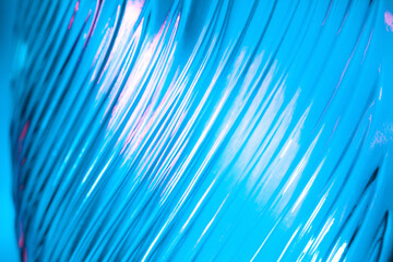 abstract glass background. texture of wavy glass illuminated with multi-colored light. pink and blue
