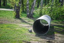 A Large Corrugated Pipe, Prepared For Installation, Lies On The Ground In A Park Or Square. Production Of Storm Collector Sewers. For City Underground Water Heating System