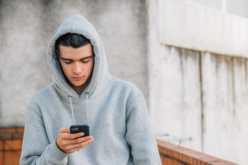 Canvas Print - young urban male teenager in the street with mobile phone