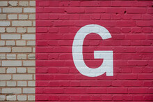 White Letter G Painted To Brick Wall On Natural And Red Background (from A Letter Set Containing B, C, D, F, G, M, R And 1, 3, 4)