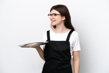 Wall Mural - Young Russian woman chef with tray isolated on white background looking side