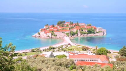 Fototapete - Gorgeous view of the small islet Sveti Stefan. Filmed in UHD 4k video.