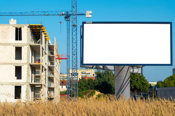 Blank white advertising billboard on the construction site area