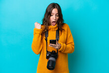 Young Photographer Woman Isolated On Blue Background Surprised And Sending A Message
