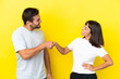© luismolinero - Young couple isolated on yellow background handshaking after good deal