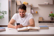 © Elnur - Young male student studying at home during pandemic