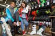 © JackF - Buyers man and woman are trying on modern boots which they choose for skiing in a sporting goods store