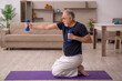 © Elnur - Old man doing sport exercises at home