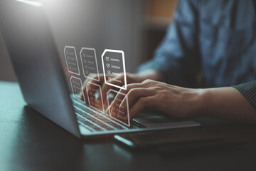 document management concept with icons on virtual screen, erp, businessman working on laptop compute