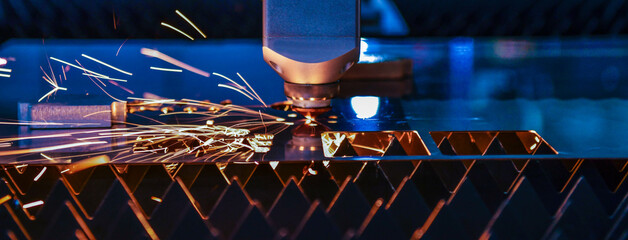 Wall Mural - industrial laser cut machine while cutting the sheet metal with the sparking light. banner side