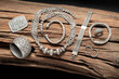 Collection of antique silver jewellery on an old wood log