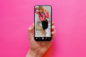Wall Mural - sample social media app with shared video content on screen, concept of people using social media pl